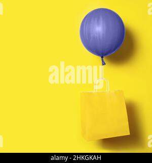 Very peri violet ballon holding yellow package delivery on yellow background Stock Photo