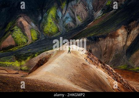 Hiker in front of colourful mountains in Landmannalaugar. Stock Photo