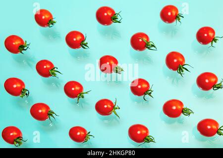 Juicy red cherry tomatoes on a blue background. Pattern, wallpaper, food background. Stock Photo