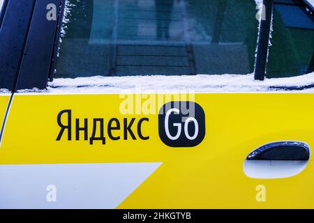 The logo of the Yandex.Go (Russian: Yandex.Go) application on the cab car door is an international company that operates a cab aggregation business in Stock Photo