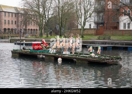 Father Christmas on his sleigh on Chichester Canal West Sussex England Stock Photo