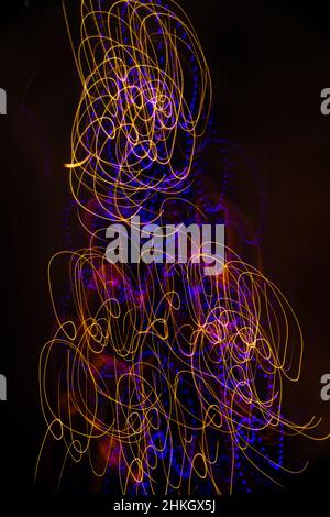 colorful streaks designs lights special effect background made by long time exposure  intentional camera movement creating celebratory light motion Stock Photo
