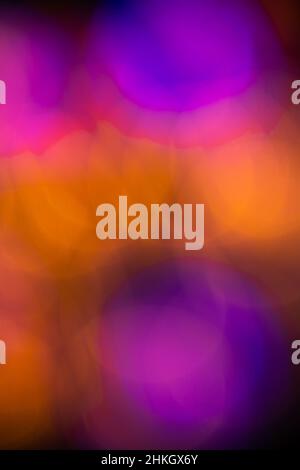 abstract circular colorful bokeh effect created by intentional out of focus colored overlapping circles to create blending color vertical background Stock Photo