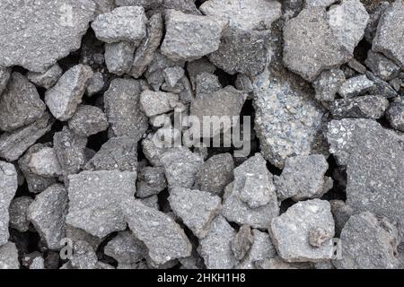 Pile of old cracked asphalt rubble close up, abstract industrial background. Stock Photo
