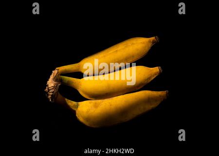 Bunch of ripe bananas on a black background. Stock Photo