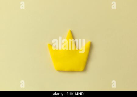 Simple 3d yellow crown symbol on yellow background. Concept of win and success, king sign, top rank quality status. Stock Photo