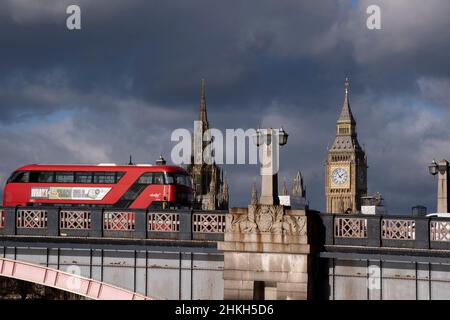 A bus crosses Lambeth Bridge and past parliament on which, following the five-year conservation project of the Houses of Parliament, scaffolding is finally coming down to reveal its renovated architecture, on 4th February 2022, in London, England. Apart from New Year chimes, the Big Ben bell inside the Elizabeth Tower, has remained silent during parliament's extensive renovation by contractor Sir Robert McAlpine with an approximate cost of £61m.