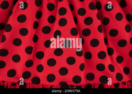 Texture of red fabric with black polka dots - top view and close-up of a fragment of wrinkled cotton fabric Stock Photo