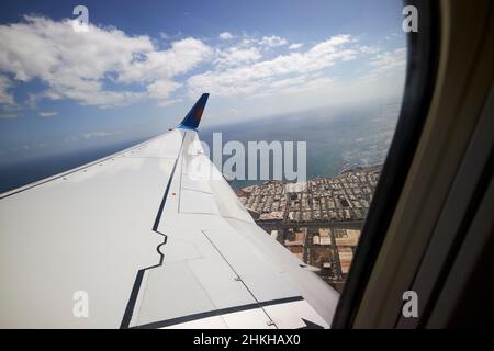 on board aircraft looking out window of plane just taken off from arrecife airport Lanzarote Canary Islands Spain Stock Photo