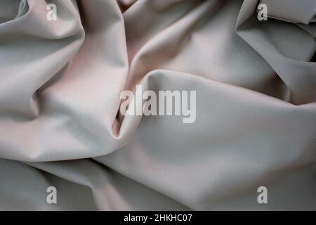Fabric gray in folds top view. Close-up of the folds of the dress. Polyester folds texture. Stock Photo
