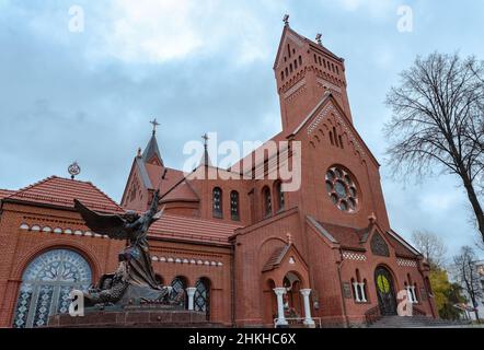 MINSK, BELARUS - November 08 Catholic Church of St. Simon and St. Helena with big cloudy sky with statue of Archangel Michael with outstretched wings, Stock Photo