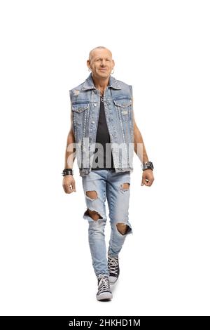 Bald man in a denim vest walking towards camera isolated on white background Stock Photo