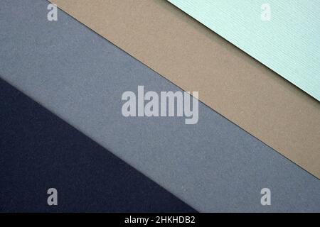 Paper background with diagonal lines. Different colors of paper top view. Black, gray, brown diagonal lines, pastel colors. Stock Photo