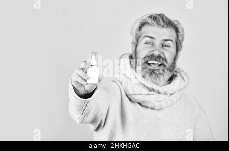 pandemic concept. man treat runny nose with nasal spray. free your stuffy nose. no addiction to medicals. coronavirus from china. happy hipster Stock Photo