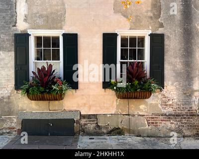 Architectural detail and window boxes seen in the historic district of Charleston, South Carolina, a luxury slow travel destination in the southeaster Stock Photo