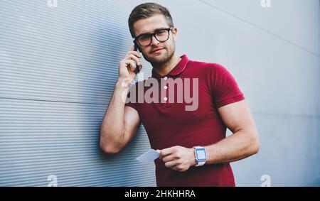 Cheerful male talking on smartphone Stock Photo