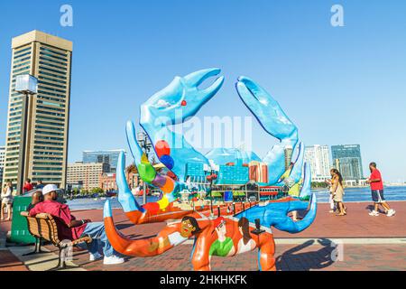 Baltimore Maryland,Inner Harbor Harborplace,Patapsco River World Trade Center,Black man woman couple,downtown skyline,fiberglass crab sculpture art Stock Photo