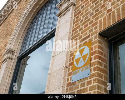 Old vintage fallout shelter sign on a brick exterior wall Stock Photo