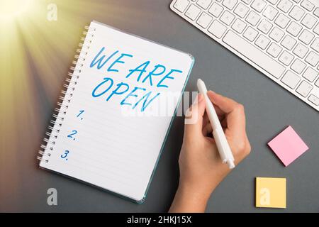 Writing displaying text We Are Open. Internet Concept We Are Open Keyboard Over A Table Beside A Notebook And Pens With Sticky Notes Stock Photo