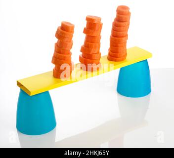 Stacks of chopped carrots balanced on plastic cups Stock Photo