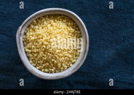 Uncooked Couscous in a Bowl Stock Photo