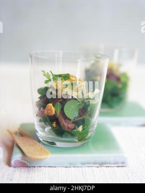 Two glasses containing tamarind beef with peanuts Stock Photo
