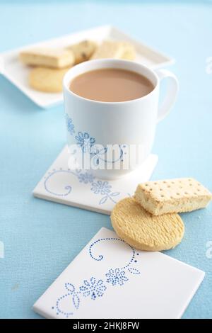 Cup of milky tea, butter biscuits and shortbread Stock Photo