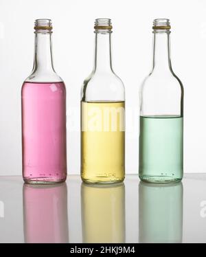 Bottles filled with different amounts of coloured water Stock Photo