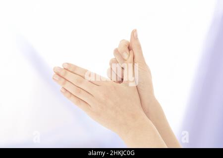Pressing index finger on to the thumb Stock Photo