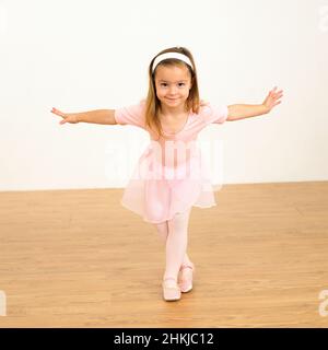 Girl in ballerina outfit with arms outstretched Stock Photo