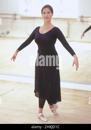 Ballet teacher wearing black leotard and long chiffon skirt Stock Photo