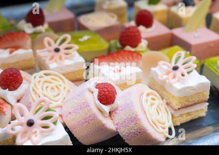 A lot of pink roll cakes and small cakes Stock Photo