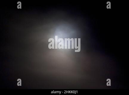 full moon in the cloudy night sky, Germany, Bavaria Stock Photo