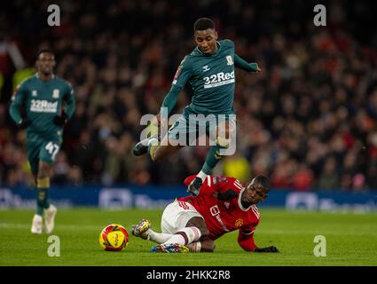 Manchester, UK. 5th Feb, 2022. Middlesbrough's Isaiah Jones (top) is tackled by Manchester United's Paul Pogba during the English FA Cup fourth round match between Manchester United and Middlesbrough in Manchester, Britain, Feb. 4, 2022. Credit: Xinhua/Alamy Live News Stock Photo