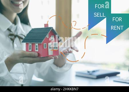 A woman holding and checking house model .Real Estate House Appraisal And Inspection and Insurance concept. Stock Photo