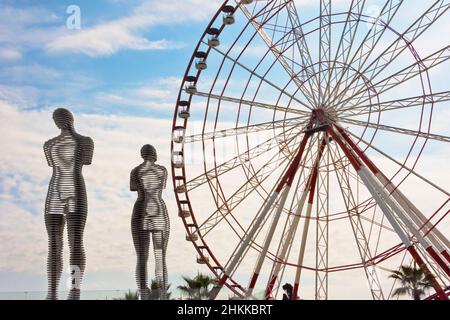 Making love monument, Ali & Nino, the figures move toward each other and merge into one piece every ten minutes, and ferris wheel  on the coast of the Stock Photo