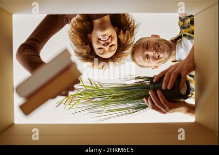 Couple packing boxes for move bottom view Stock Photo