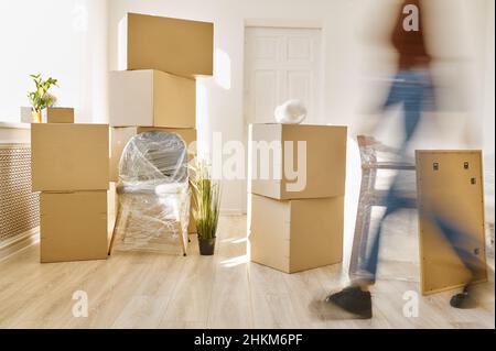 Person moving fast among plenty of boxes Stock Photo