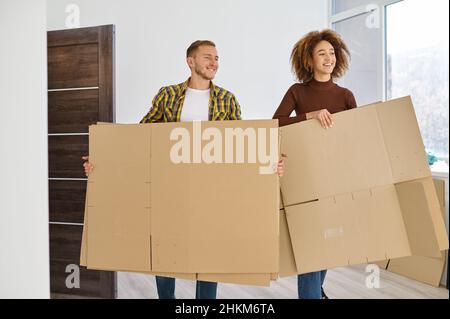 Happy couple carrying carton for packing stuff Stock Photo
