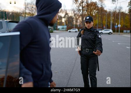 Police officer trying talk with car thief Stock Photo - Alamy