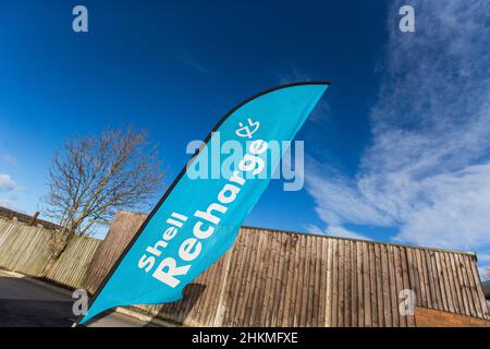 A Shell Recharge - Allego Charging Station for electric powered vehicles at a Shell petrol station on A168 near Thirsk in North Yorkshire, UK. Pictured with a blue sky. Stock Photo