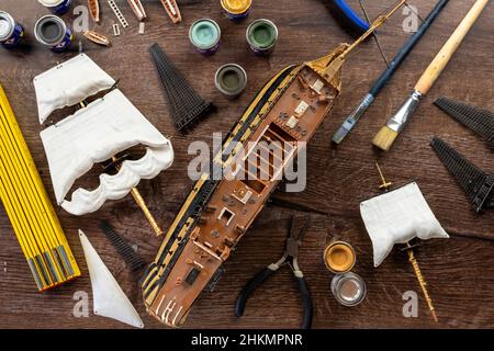 Model Ship Building handcraft on table with different materials Stock Photo