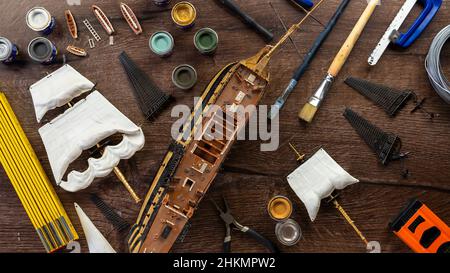 Model Ship Building handcraft on table with different materials Stock Photo
