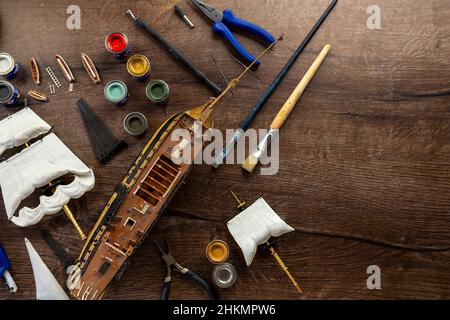 Model Ship Building handcraft on table with different materials Stock Photo