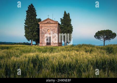 One of the most visited small religion building on the grain field, Vitaleta chapel, Tuscany, Italy, Europe Stock Photo