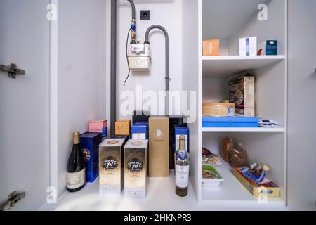 Open cabinets in a new kitchen set. Almost empty shelves. Stock Photo