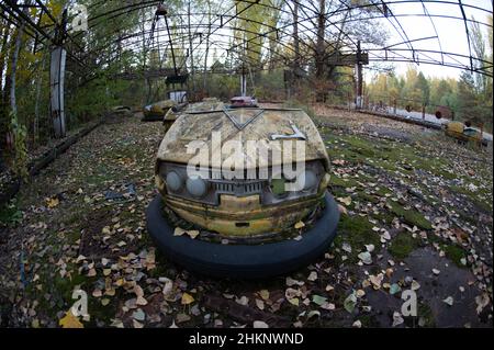 The infamous amusement park (bumper cars and ferris wheel) in Pripyat, Ukraine lies deserted years after the Chernobyl disaster. Stock Photo