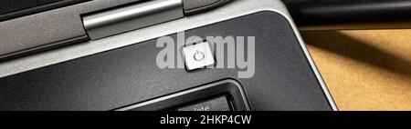 Laptop computer simple silver power button, switch, object detail, closeup, detail, wide shot, nobody. Appliance, device, hardware on switch, powering Stock Photo