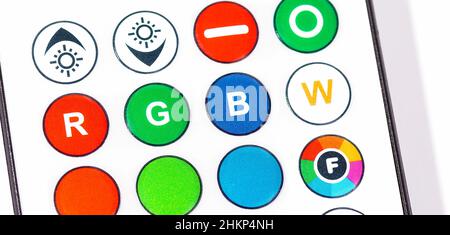 RGB Red green blue smart home lighting control remote control buttons object extreme closeup, detail. Multi colored LED light controls, changing choos Stock Photo