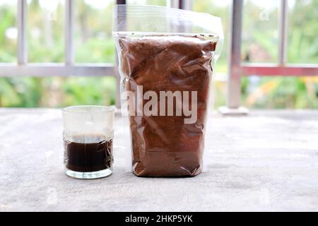Black coffee in traditional Indonesian Lampung packaging. Real coffee without mix Stock Photo